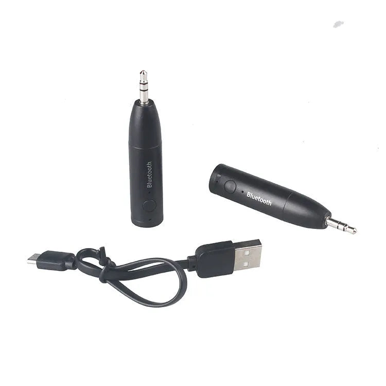 Black Bluetooth 5.0 audio receiver for car AUX or home stereo, shown with USB cable.