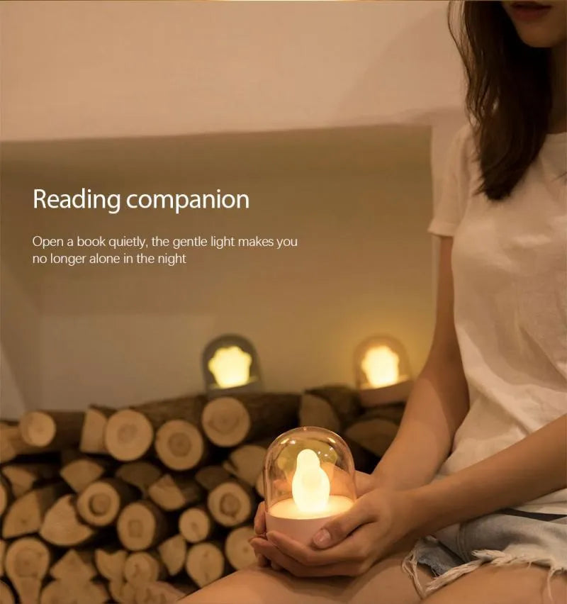 Grey and pink cat paw shaped USB rechargeable night light with rotating dynamic lighting
