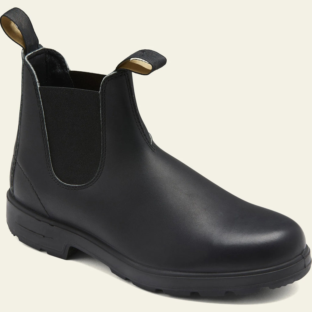 Vintage brown unisex Chelsea boot with frosted PU upper and car suture detailing on a wooden floor.