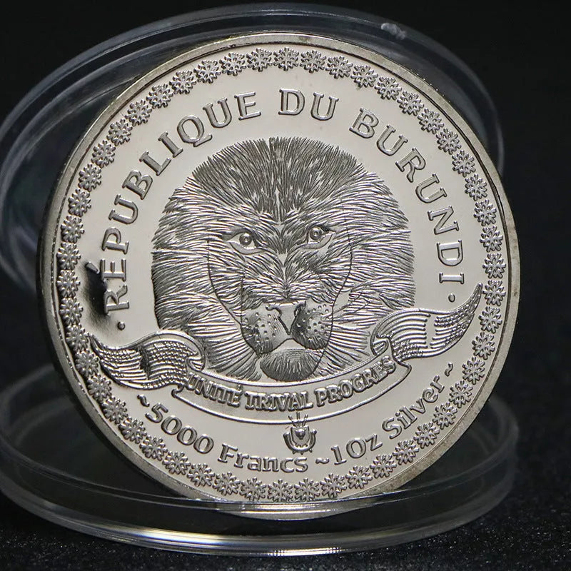 Set of eight silver plated commemorative coins with tropical fish and marine animal designs, 40mm diameter, in acrylic box