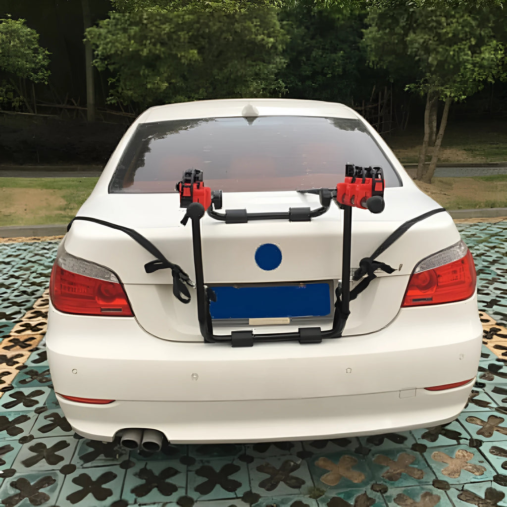 Black and red trunk mounted car bike rack with tie rope and pull belt fastening options.