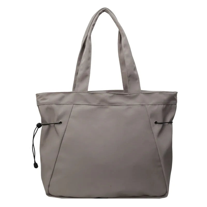 Soft foldable Oxford cloth shoulder tote bag in a street style, shown in various colours.