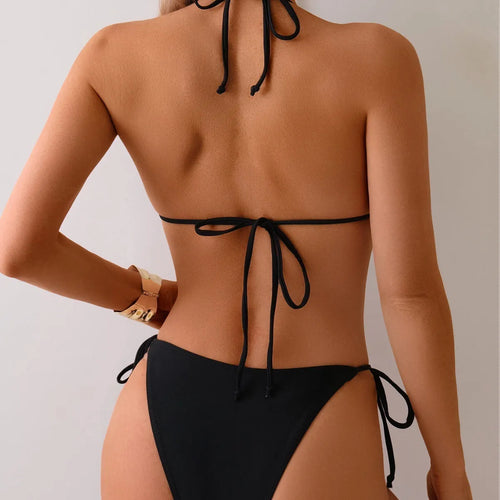 Black women's bikini swimsuit with split bottom and metal bead detail on ties.