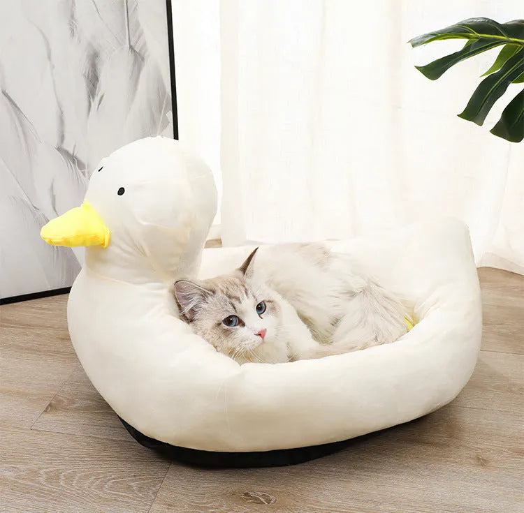 Blue duck-shaped fluffy pet bed sofa for small dogs and cats on wooden floor