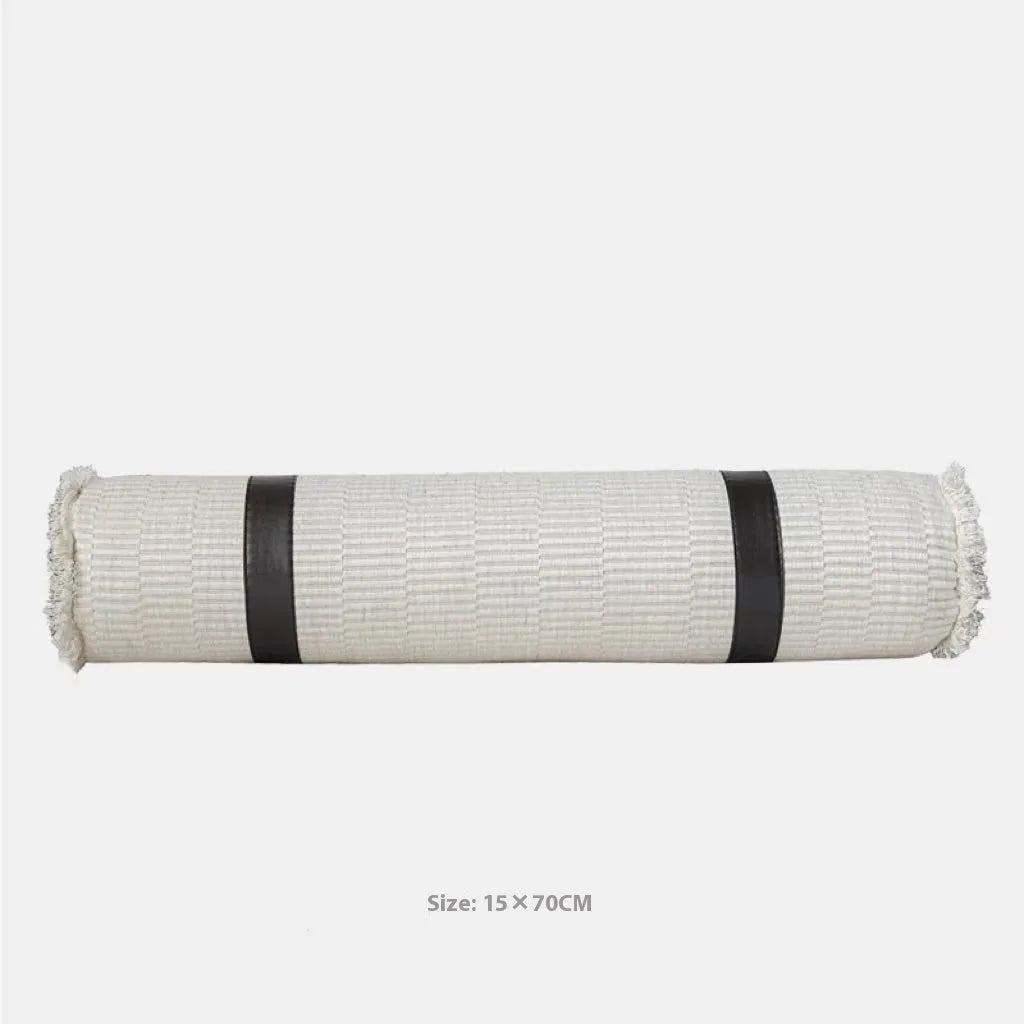 Grey and white plaid bed runner blanket set with pillowcase and round leather-look pillow on a double bed.