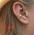 Gold-coloured women's drop earrings with a starfish and a conch shell design on an alloy post.