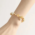 Gold electroplated bracelet featuring natural rutilated quartz crystals with golden rutile needle inclusions