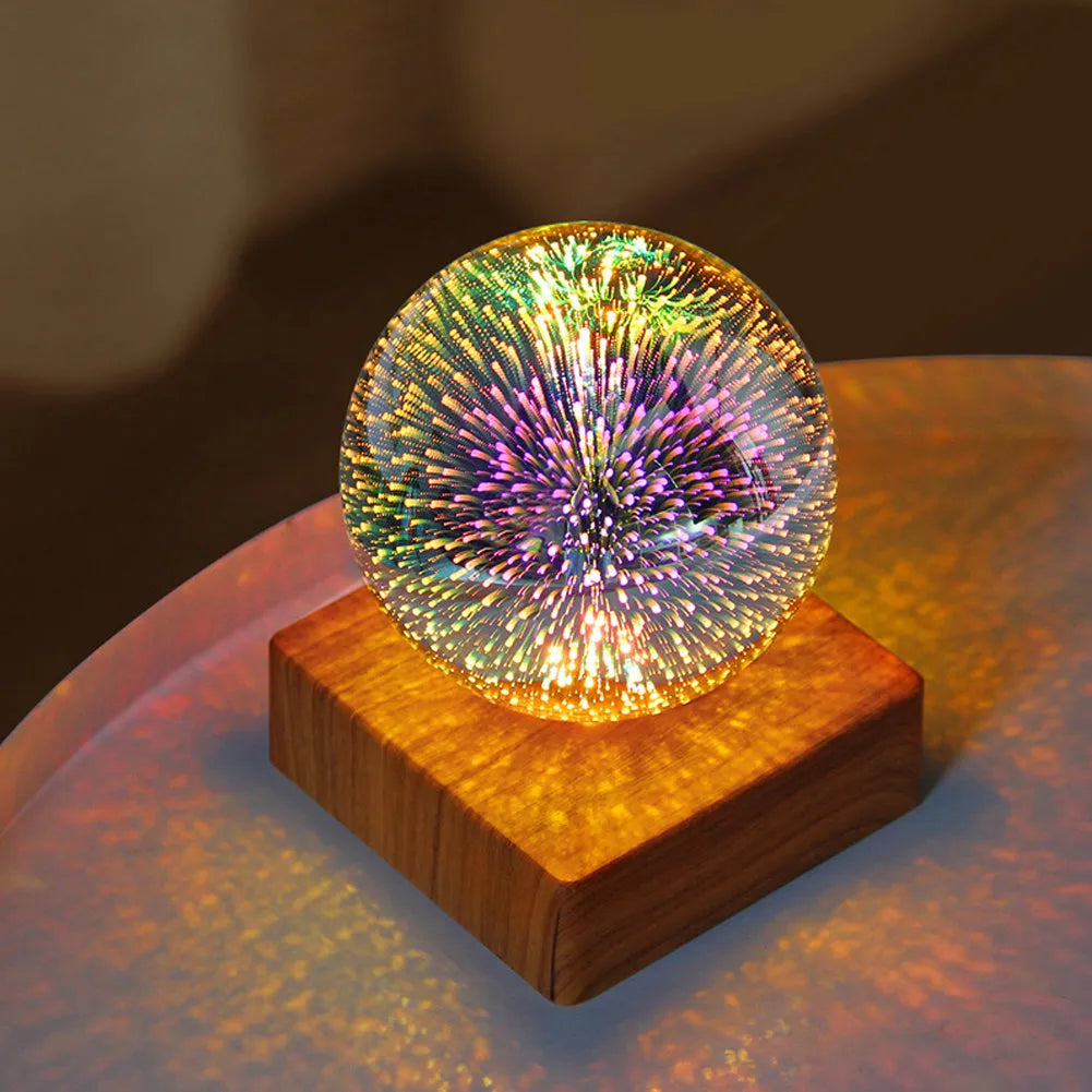 USB plug-in crystal ball LED night light showing fireworks design on a desk