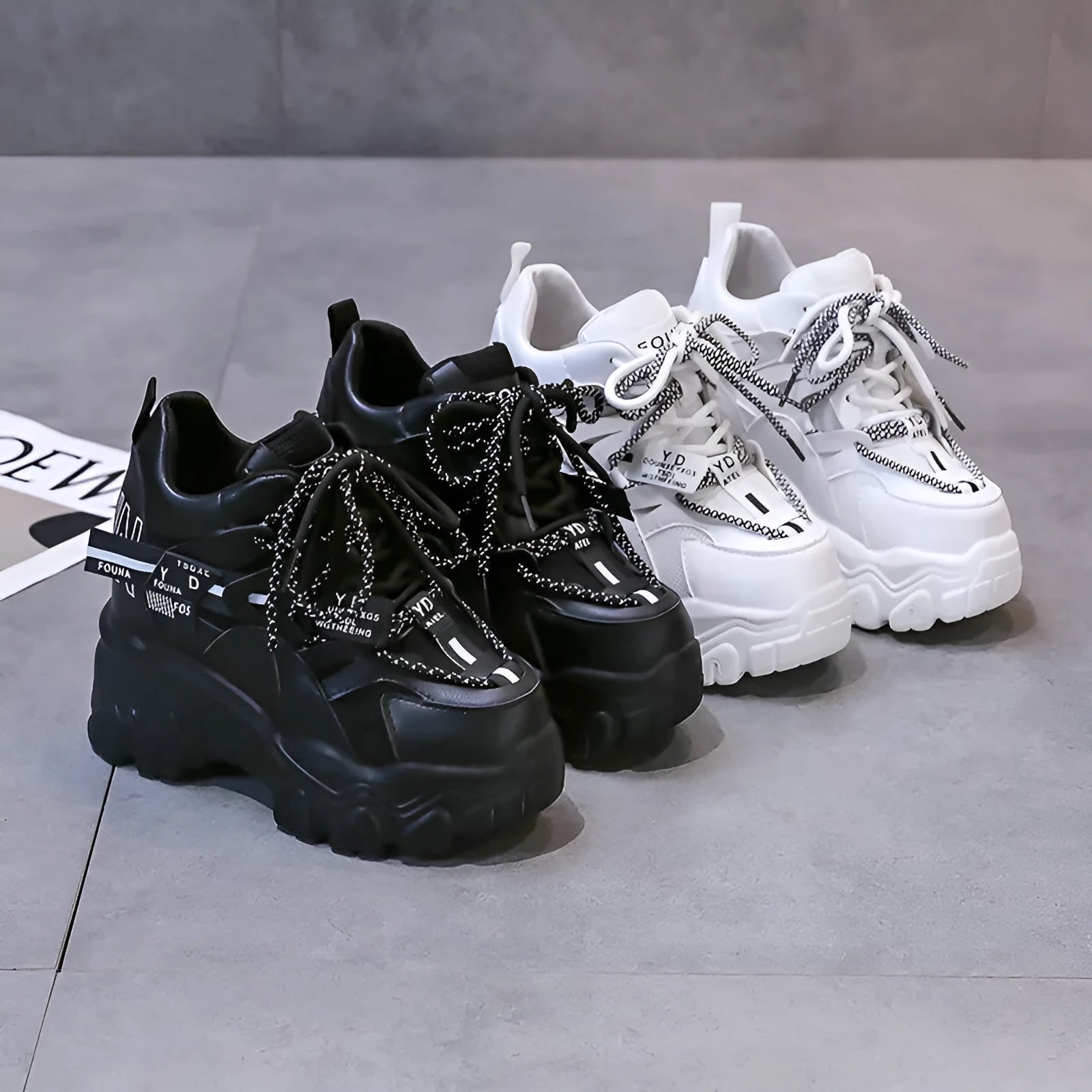 White women's low-top platform sports shoes with a cross-strap and breathable mesh upper on a rubber sole.