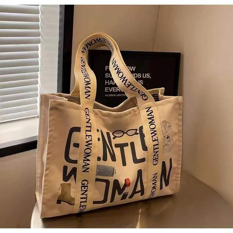 Large canvas women's tote bag with printed design, shown in available colour options.