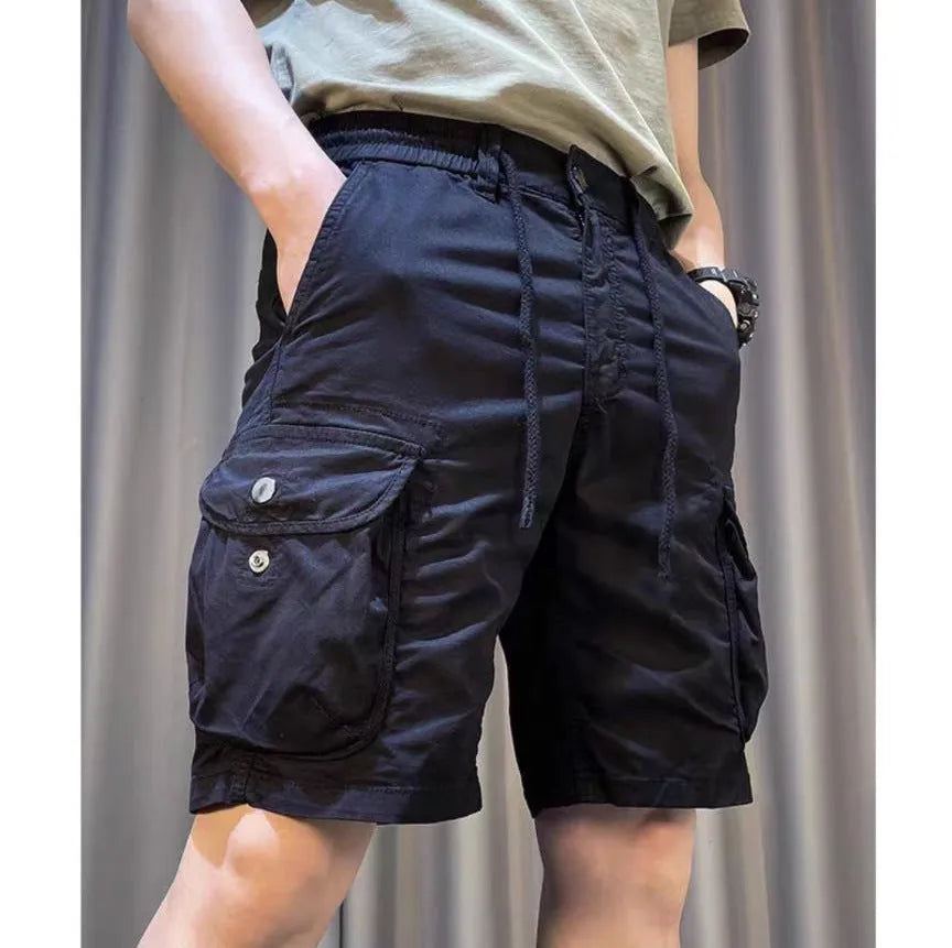 Loose straight-leg casual overalls with multiple cargo pockets in khaki, showing elastic waist and cropped length.