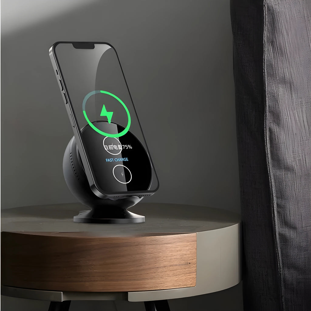 Black multifunctional wireless charging phone holder with built-in Bluetooth speaker on a desk.