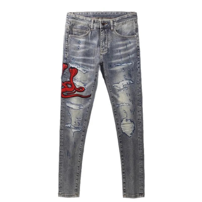 Men's slim fit washed-out denim jeans with hole patches and embroidery on a mid waist.