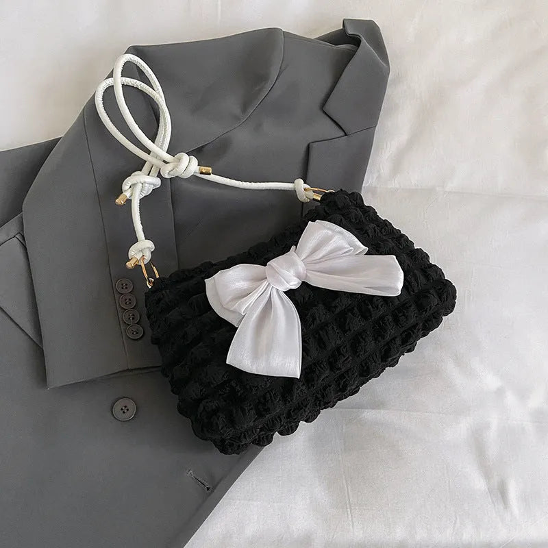 Women's canvas one-shoulder handbag in horizontal square shape with sandwich pocket, shown in black colour