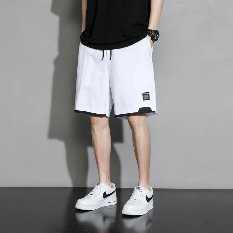 Boys' cotton shorts in black, khaki, or white, showing mid-waist and shorts length design.