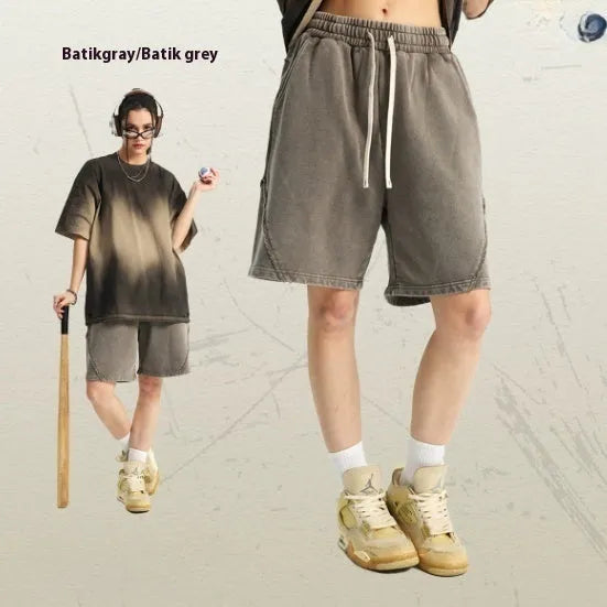 Man wearing batik pattern cotton terry shorts in a loose street fashion cut