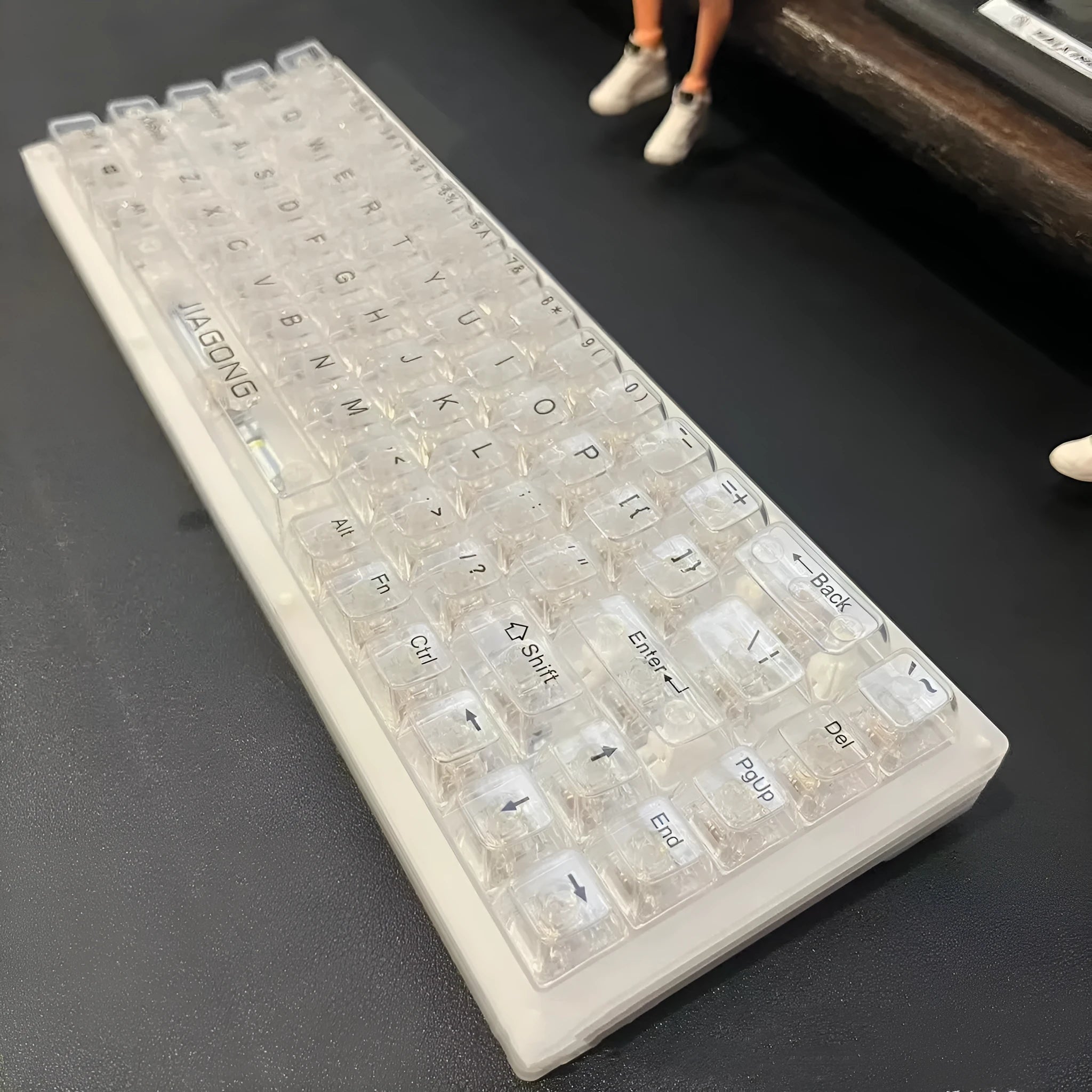 Universal transparent plastic 132-key keyboard key cap set laid out on a table.