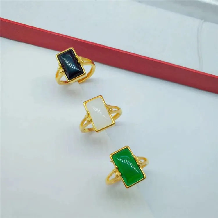 Gold-plated brass adjustable ring with a choice of black, green, or white gemstone inlays.