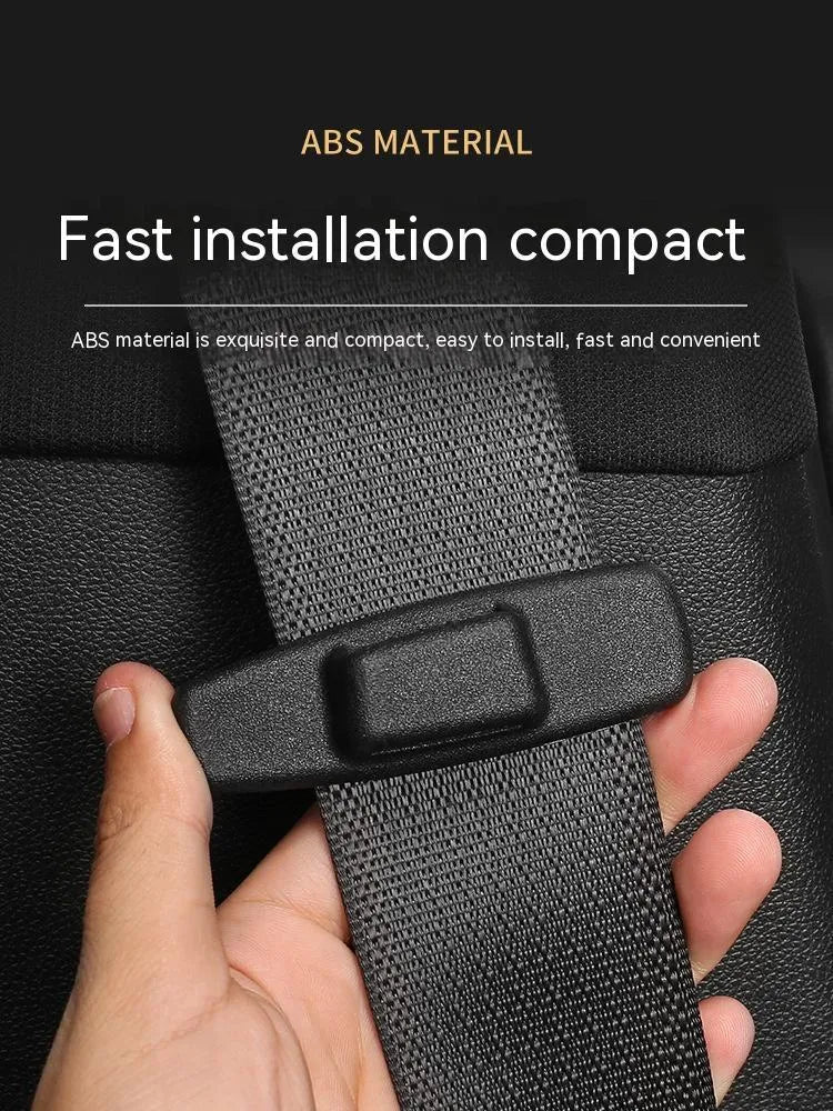 Two black ABS plastic car seatbelt adjustment clips packaged in a clear OPP bag.