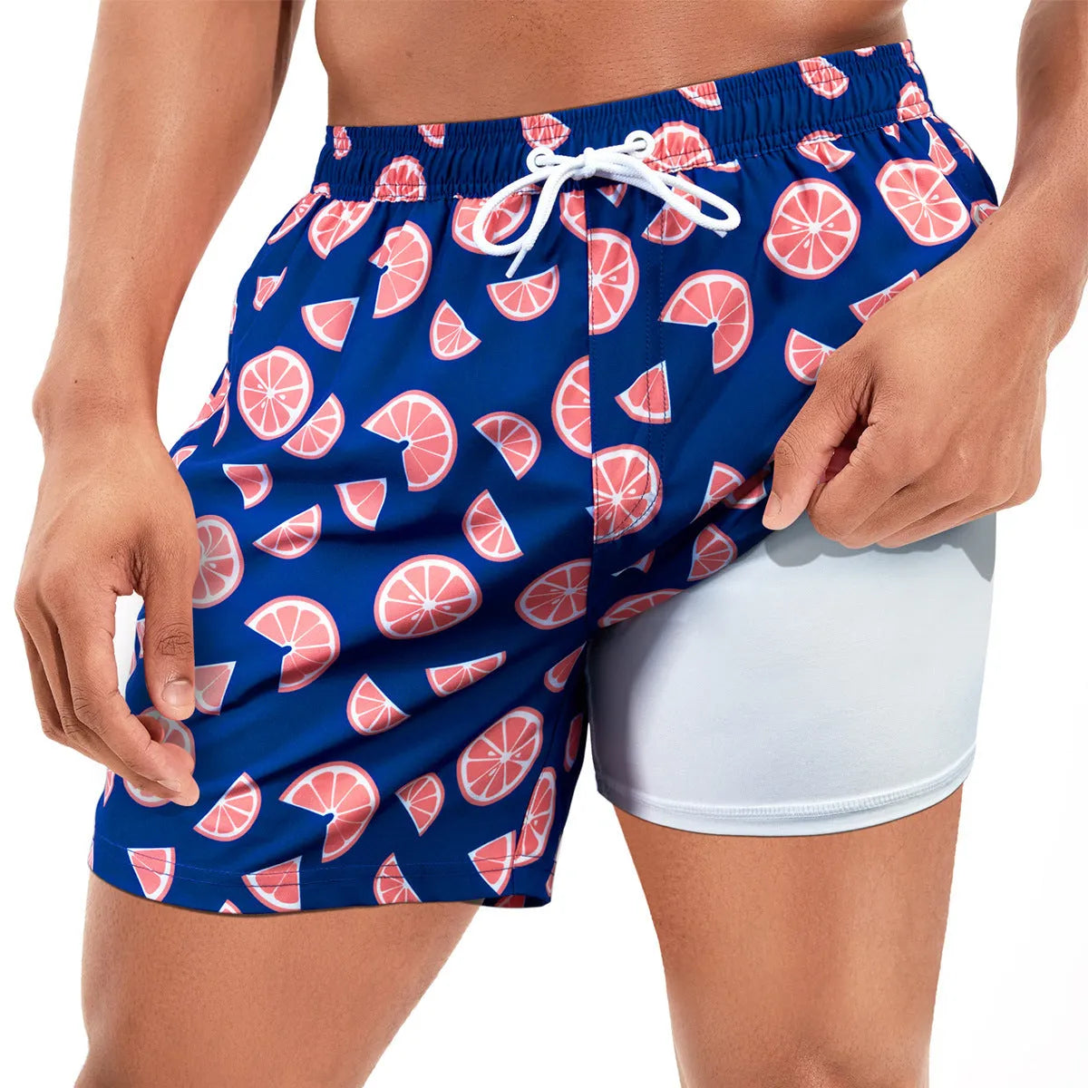 Man wearing loose green boxer-style swimming trunks made from quick-drying spandex fabric.
