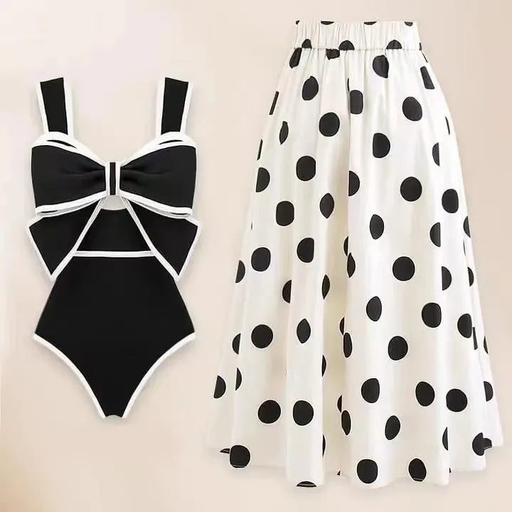 Women's black and white one-piece swimsuit with round skirt and bow detail