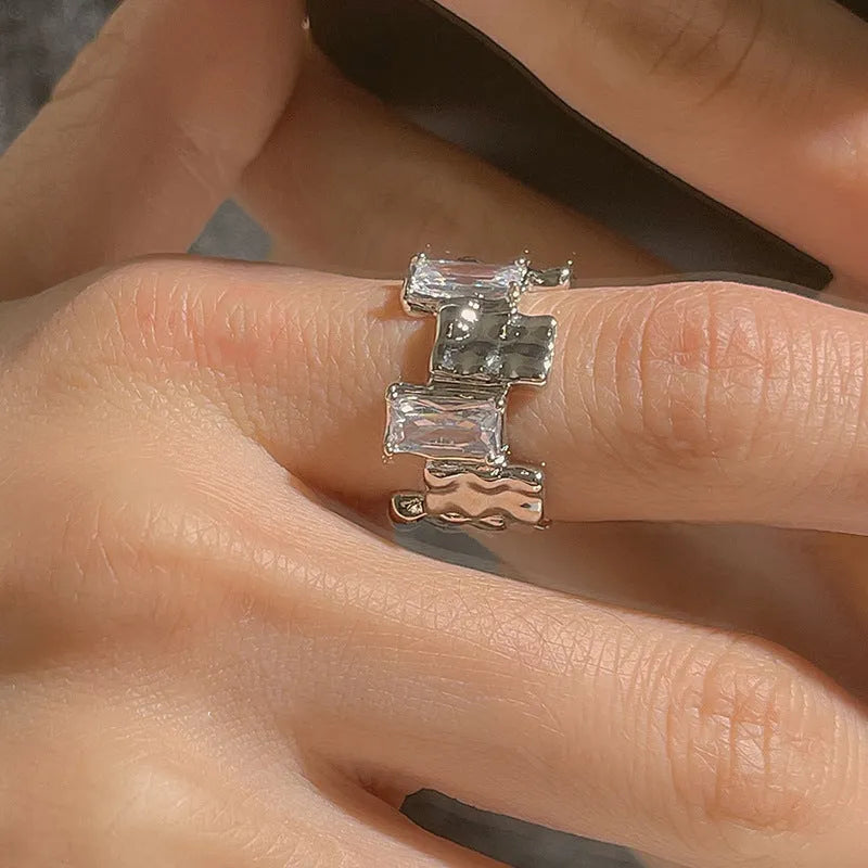Silver geometric open ring with three-dimensional decoration and cross zircon design