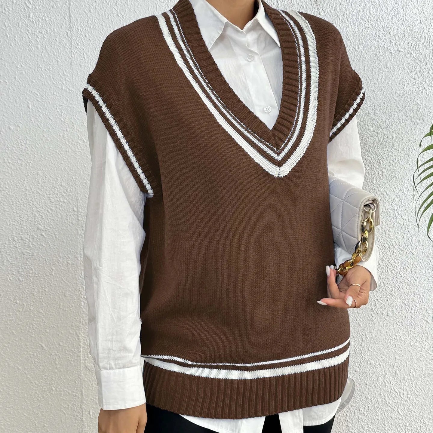 Women's loose blue college-style wool vest sweater, acrylic polyester blend, front view.