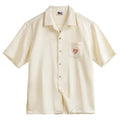 Men's light apricot shirt with bamboo leaf pattern and a Cuban collar on a short sleeve design.