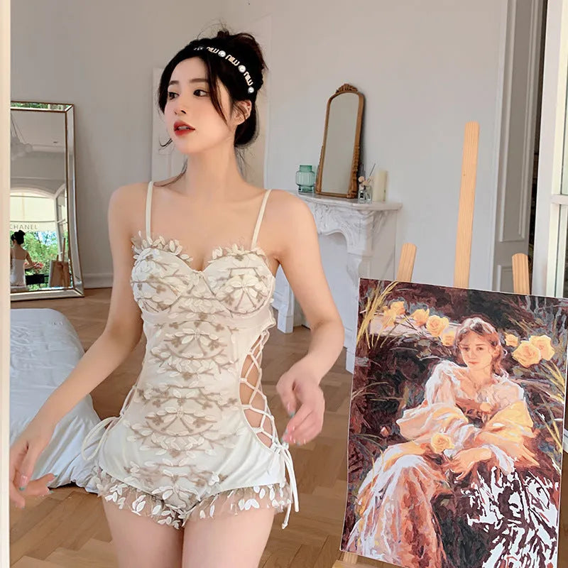 White backless one-piece swimsuit with adjustable straps, shown on a model.