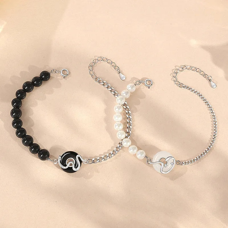 A new Chinese style 925 sterling silver bracelet with an obsidian pearl, snake zodiac charm, and a safe buckle clasp.