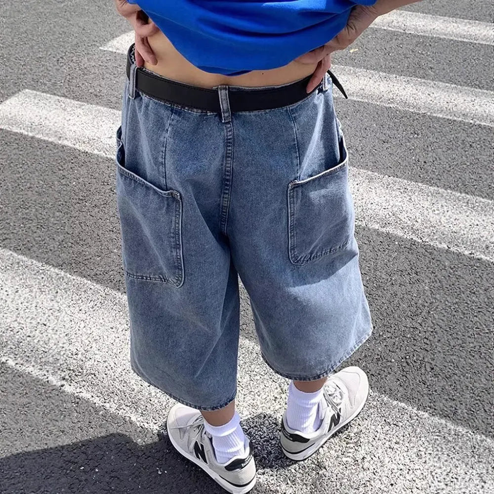 Men's blue washed denim pirate shorts with a high waist, zip fly, and straight cropped legs.