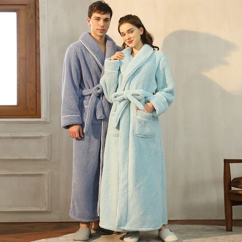 A man and woman wearing matching thick, navy blue flannel bathrobes in a European style cut.