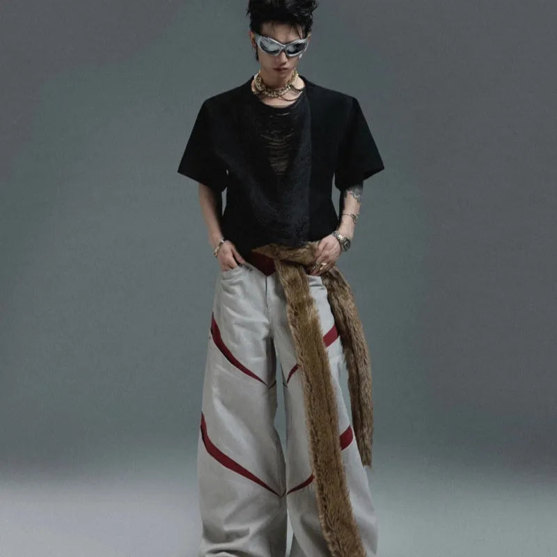 Man wearing a loose-fit drum black V-neck polyester T-shirt with short sleeves and a tassel detail.