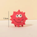 Set of four coloured squeaky dog balls with cute faces, made from natural latex rubber.