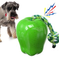 Green and red apple-shaped plastic dog toy with a textured surface and hollow centre.