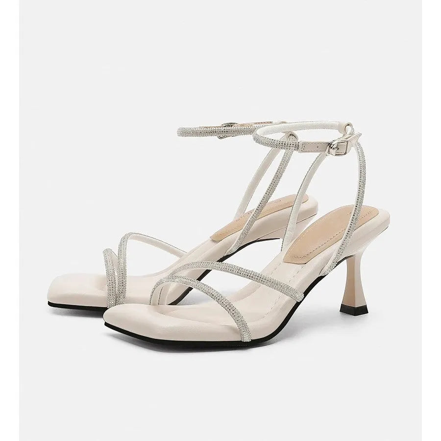 Women's silver high heel sandals with square toe, rhinestone detail, and an ankle-strap buckle.