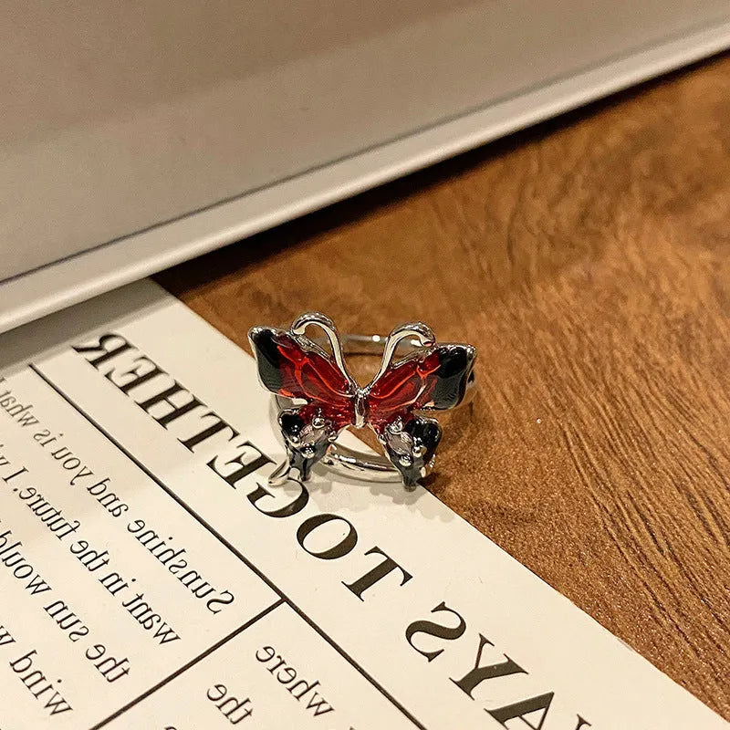 Creative butterfly design women's ring in copper with oil drip finish, showing an open loop style.