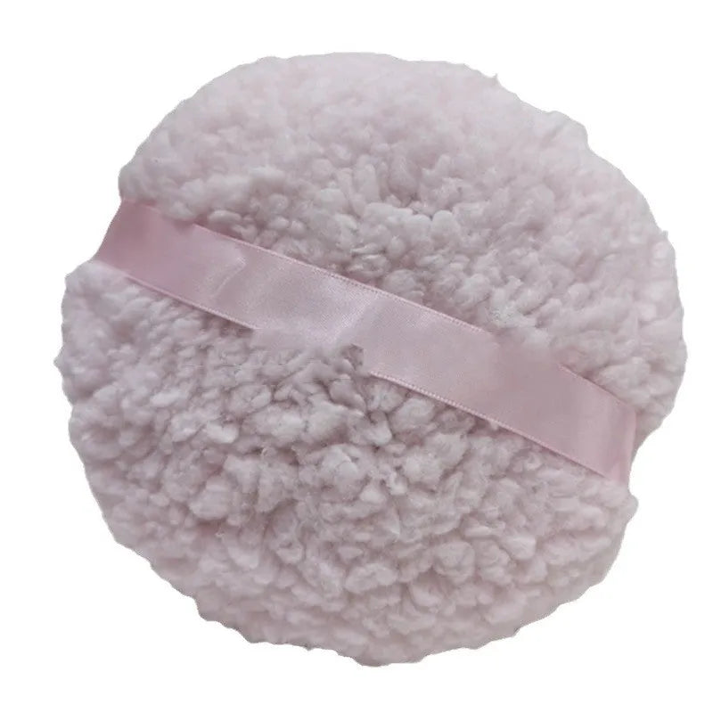 Large rectangular plush powder puff for makeup application in pink, white, or skin colour.