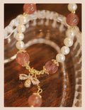 Strawberry quartz crystal bead bracelet for women with a central bow decoration.
