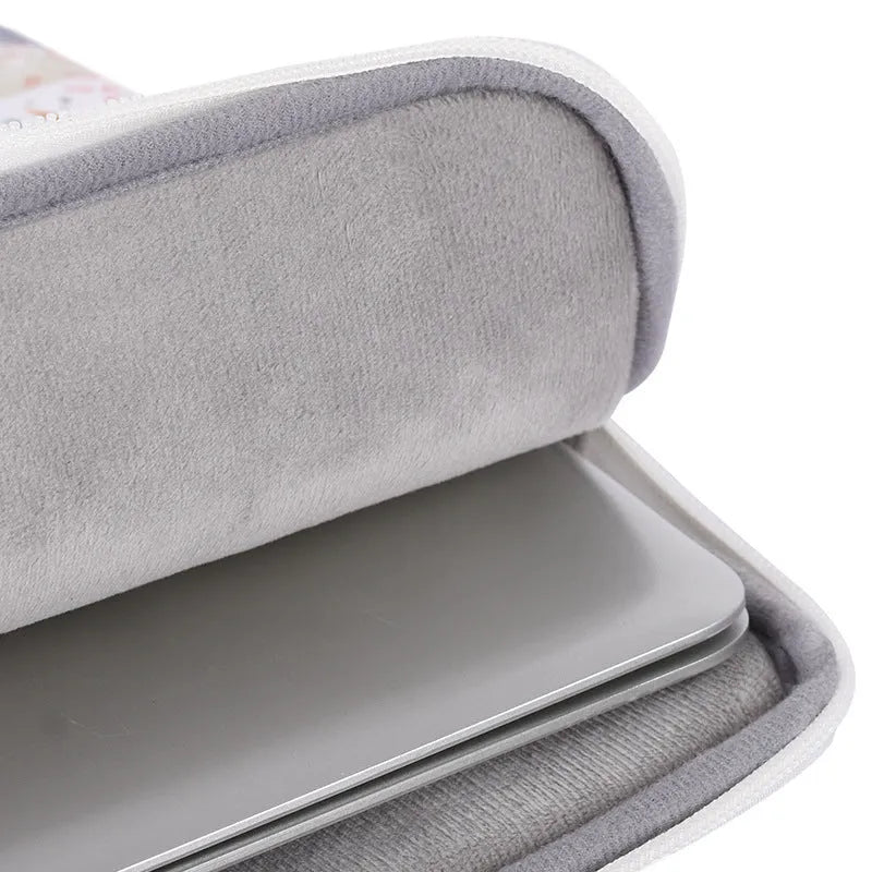 White PU leather waterproof inner sleeve for a 14 inch laptop on a table.