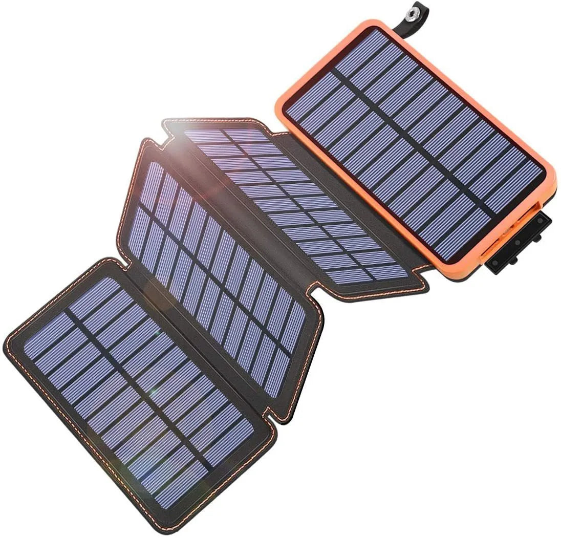 Outdoor solar power bank in black with a solar panel, soft leather finish, and LED light on a grassy field.