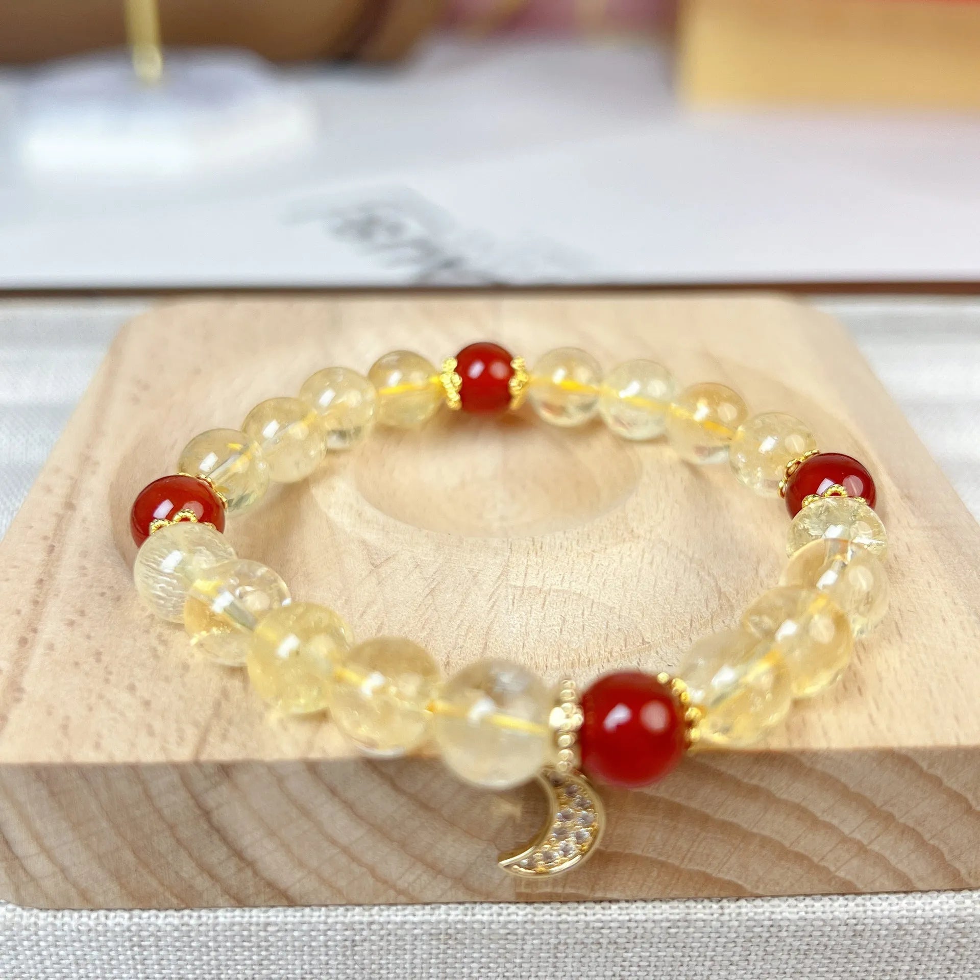 Citrine Red Agate Moon Boom Bracelet showing crystal stones and celestial charms
