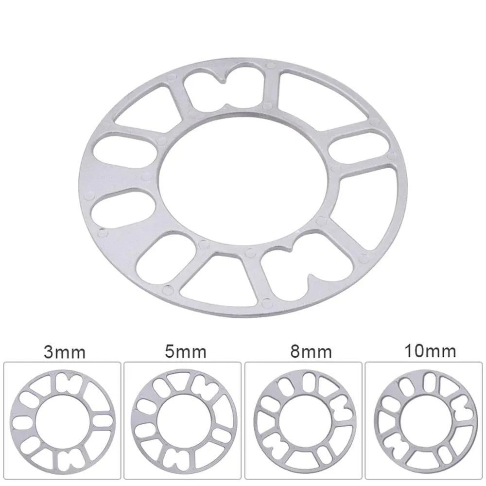 Set of metal hubcentric wheel spacer gaskets in different thicknesses for car brake caliper clearance.