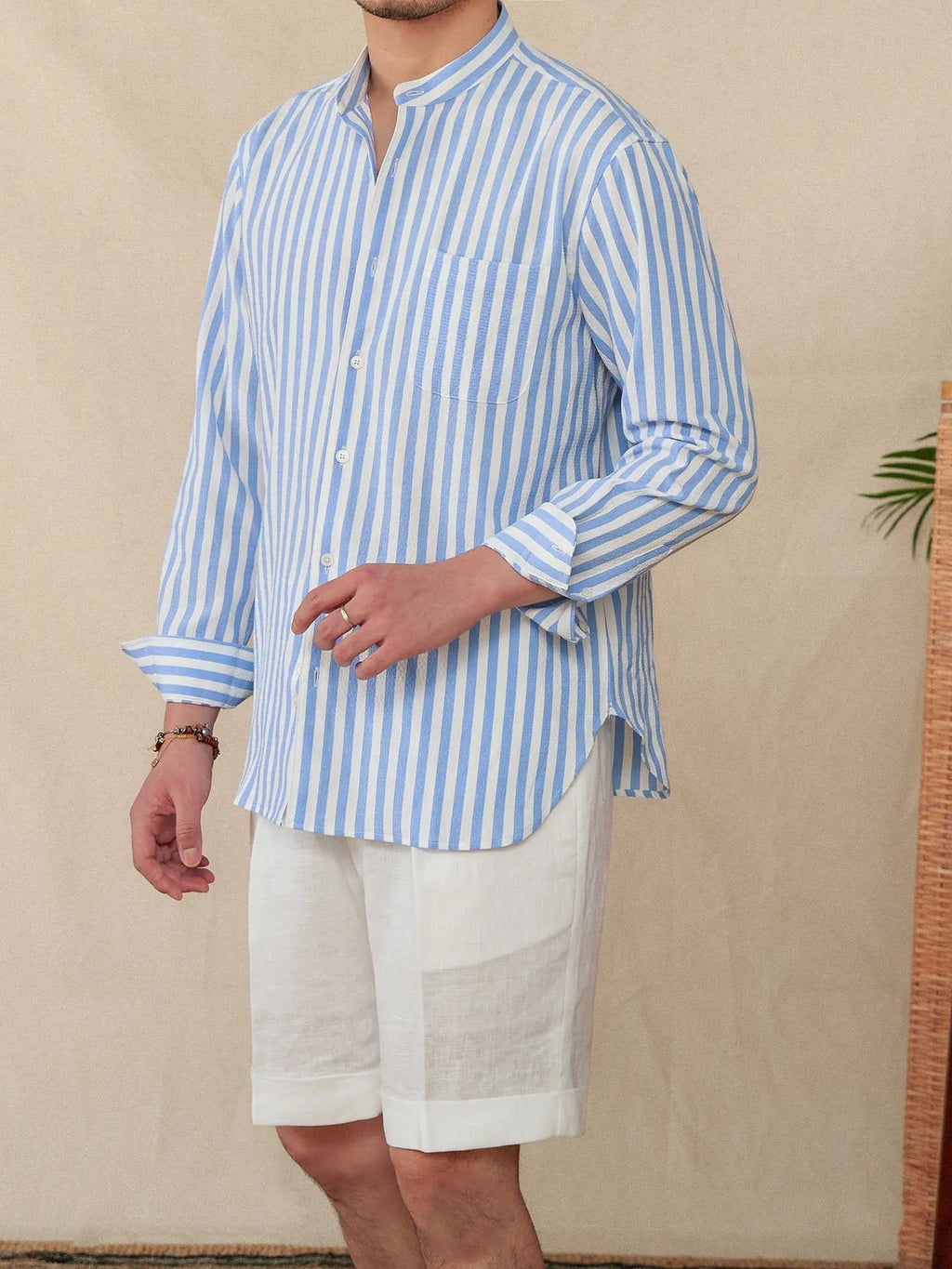 Blue and white striped seersucker long sleeve shirt with a loose lapel and baseball collar.
