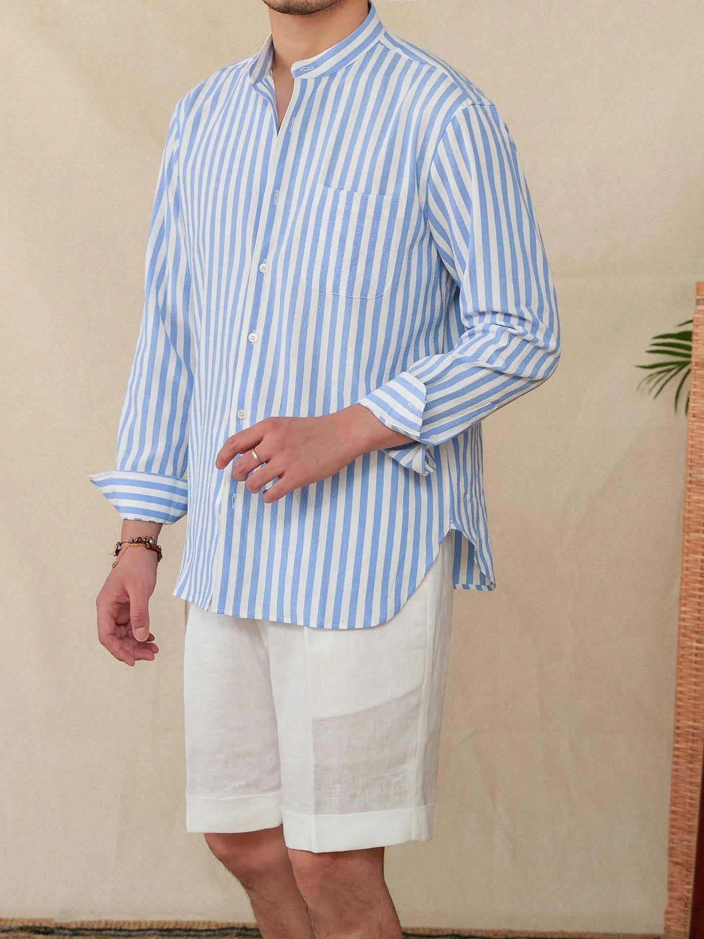 Blue and white striped seersucker long sleeve shirt with a loose lapel and baseball collar.