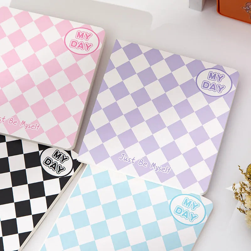 Ins style A5 grid notebook with coloured embossed fruit design cover on a desk