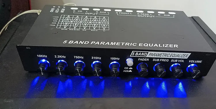 Black car audio EQ tuning amplifier with control knobs for subwoofer frequency and volume adjustment