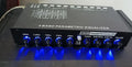 Black car audio EQ tuning amplifier with control knobs for subwoofer frequency and volume adjustment
