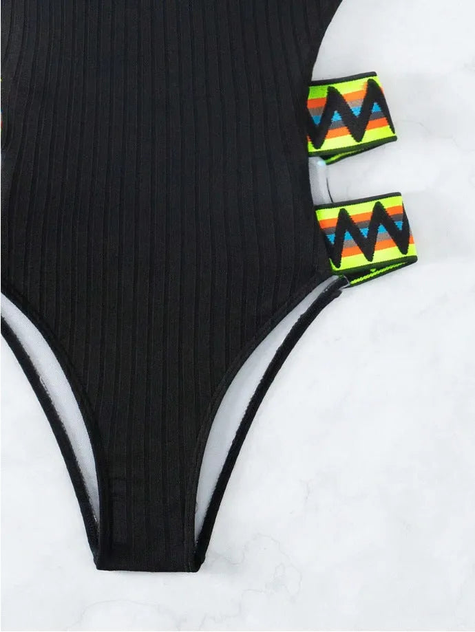 Women's solid black one-piece swimsuit with a classic style on a mannequin.