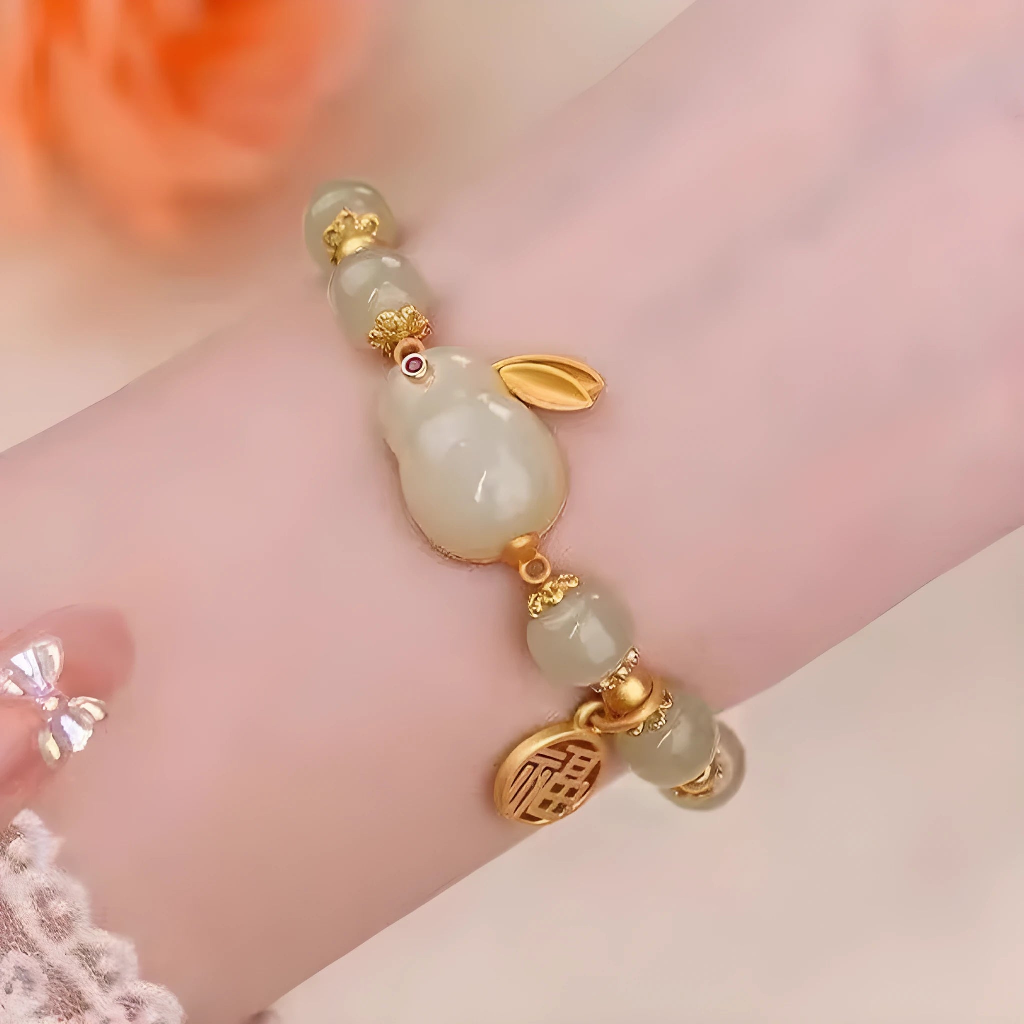 Green lucky bracelet with fu character charm, jade hare charm, and black bracelet base